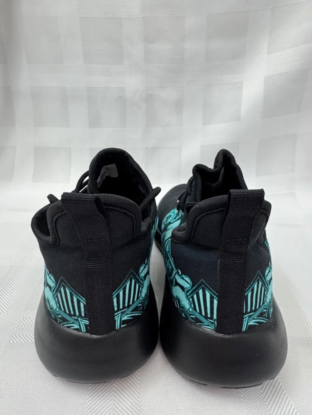 Unisex Black Lightweight Sneakers with Teal Skull Accent
